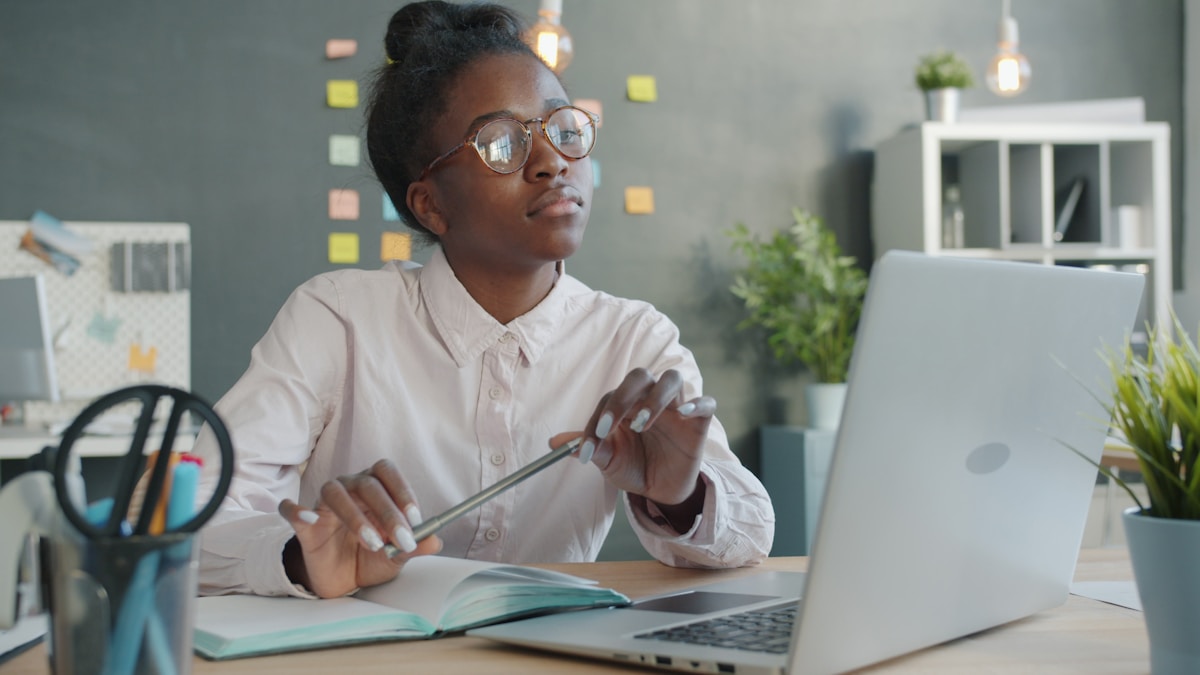 Young woman wearing glasses working at a desk