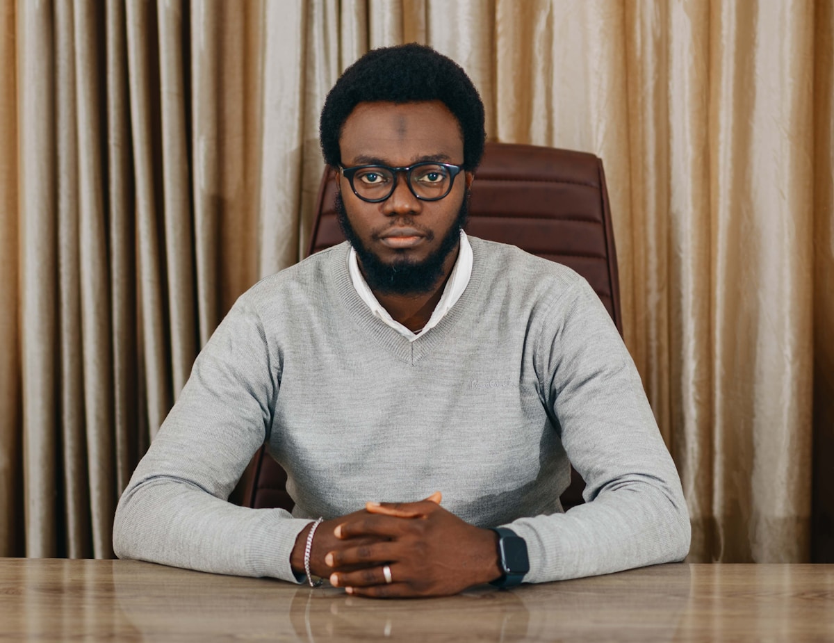 a man with glasses sitting at a table