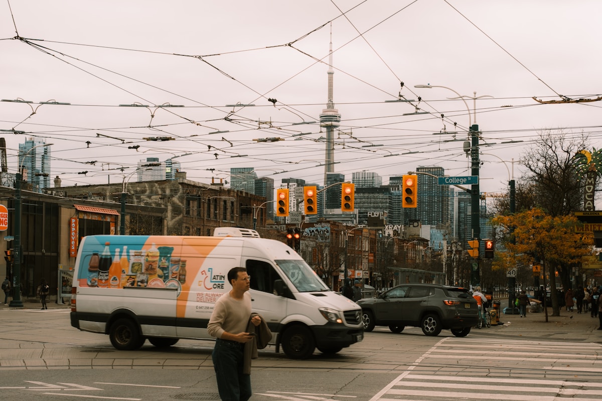 Scène urbaine animée avec gratte-ciel, tramway et piétons.