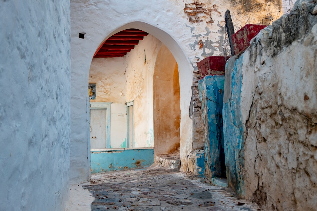 Narrow alleyway with arched passage and old buildings