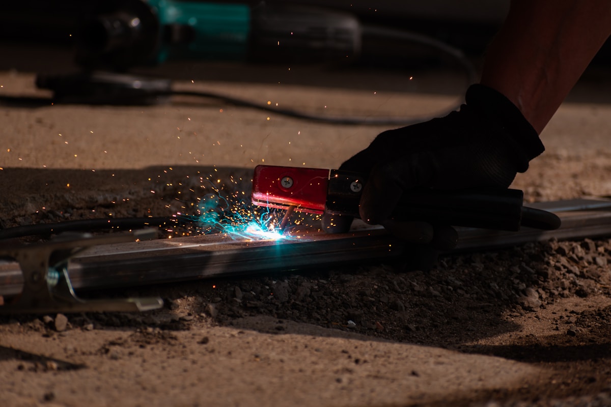 A person using a grinder on a piece of metal