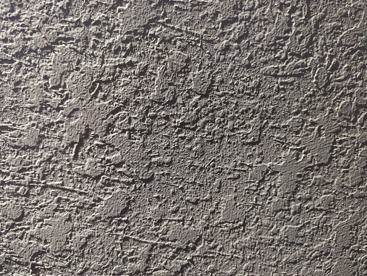 a close up of a cement wall with cracks