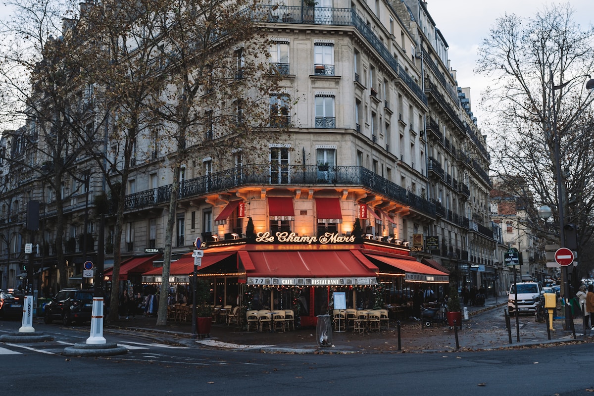 a building with a red awning in the middle of a street