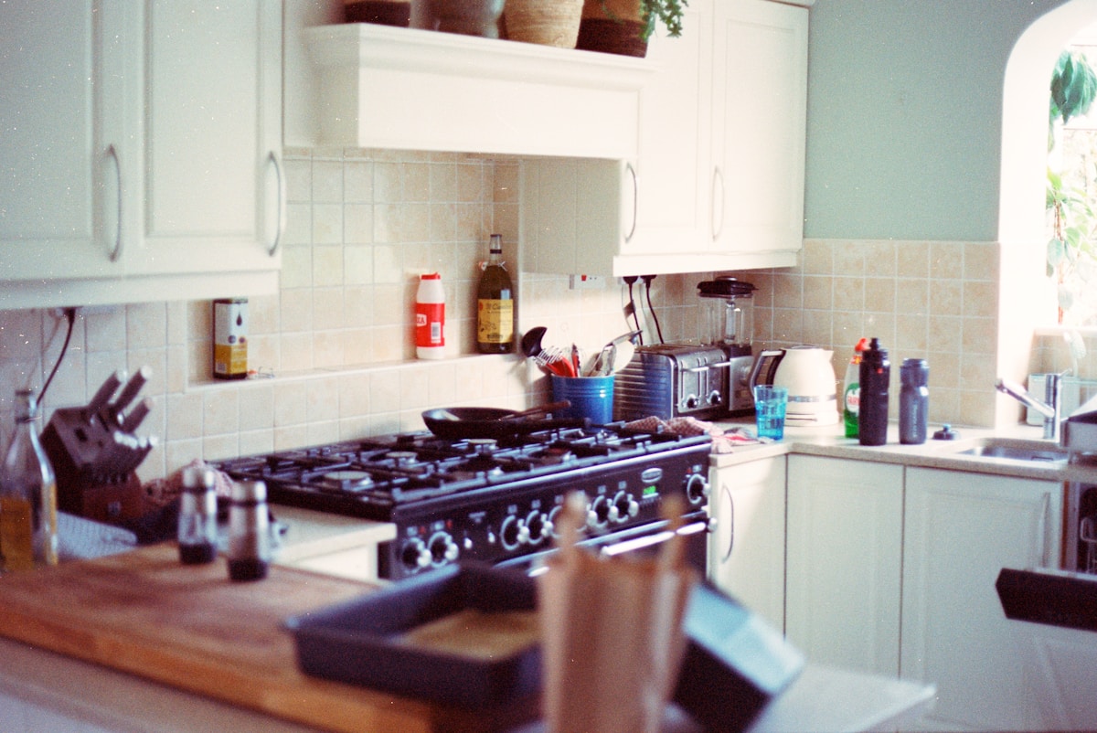 A traditional kitchen with a black gas stove.