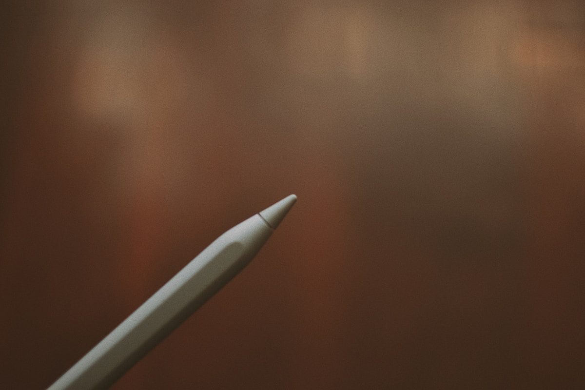silver pen on brown wooden table