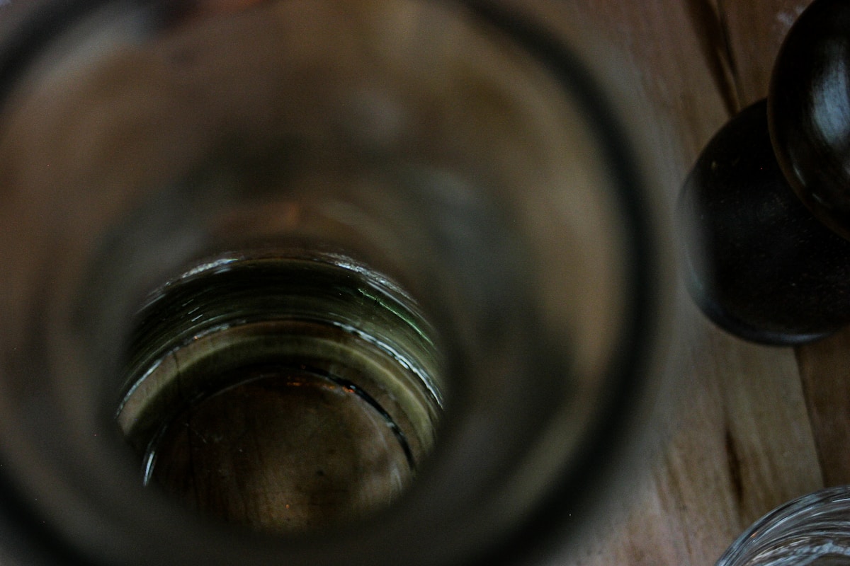 a close up of a glass on a wooden table