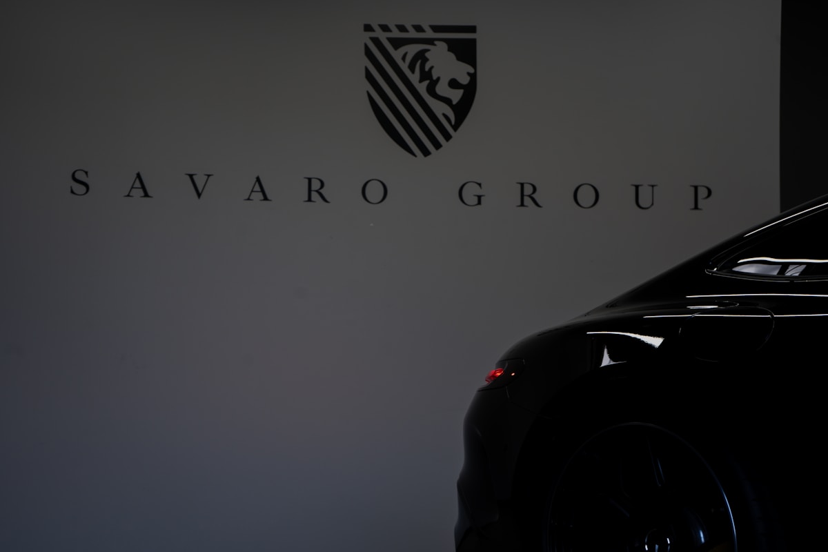 Black car in front of savaro group logo