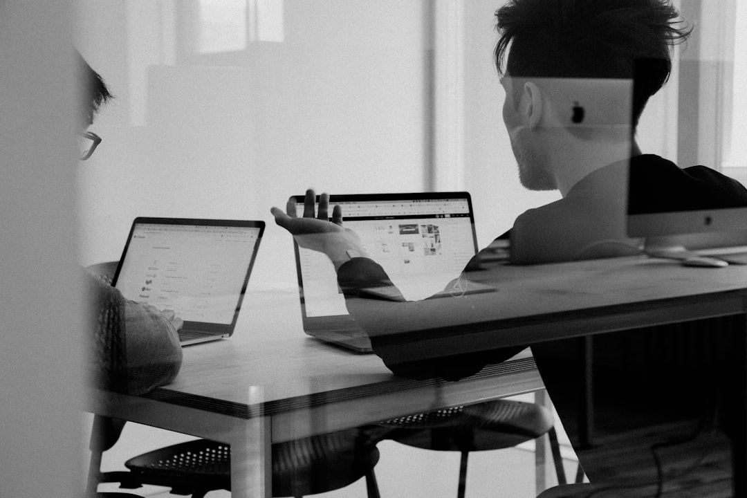 "Marketer performing seo competitor gap analysis on large monitor at standing desk, reviewing colorful bar charts and domain