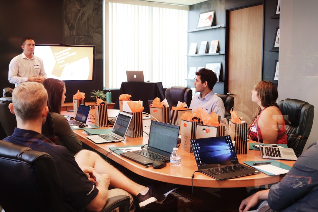Marketing team around conference table reviewing a digital analytics dashboard with organic search traffic growth metrics, re