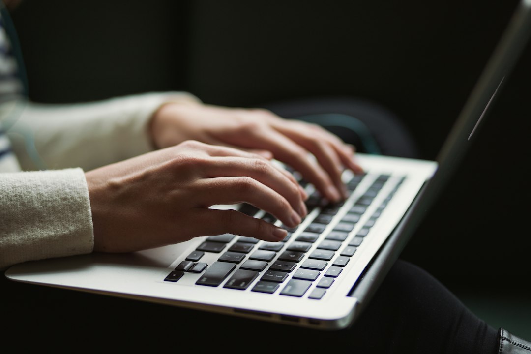Hands typing on keyboard with tabs showing SEO analytics, link building sheets, and metrics for backlink authority estimation