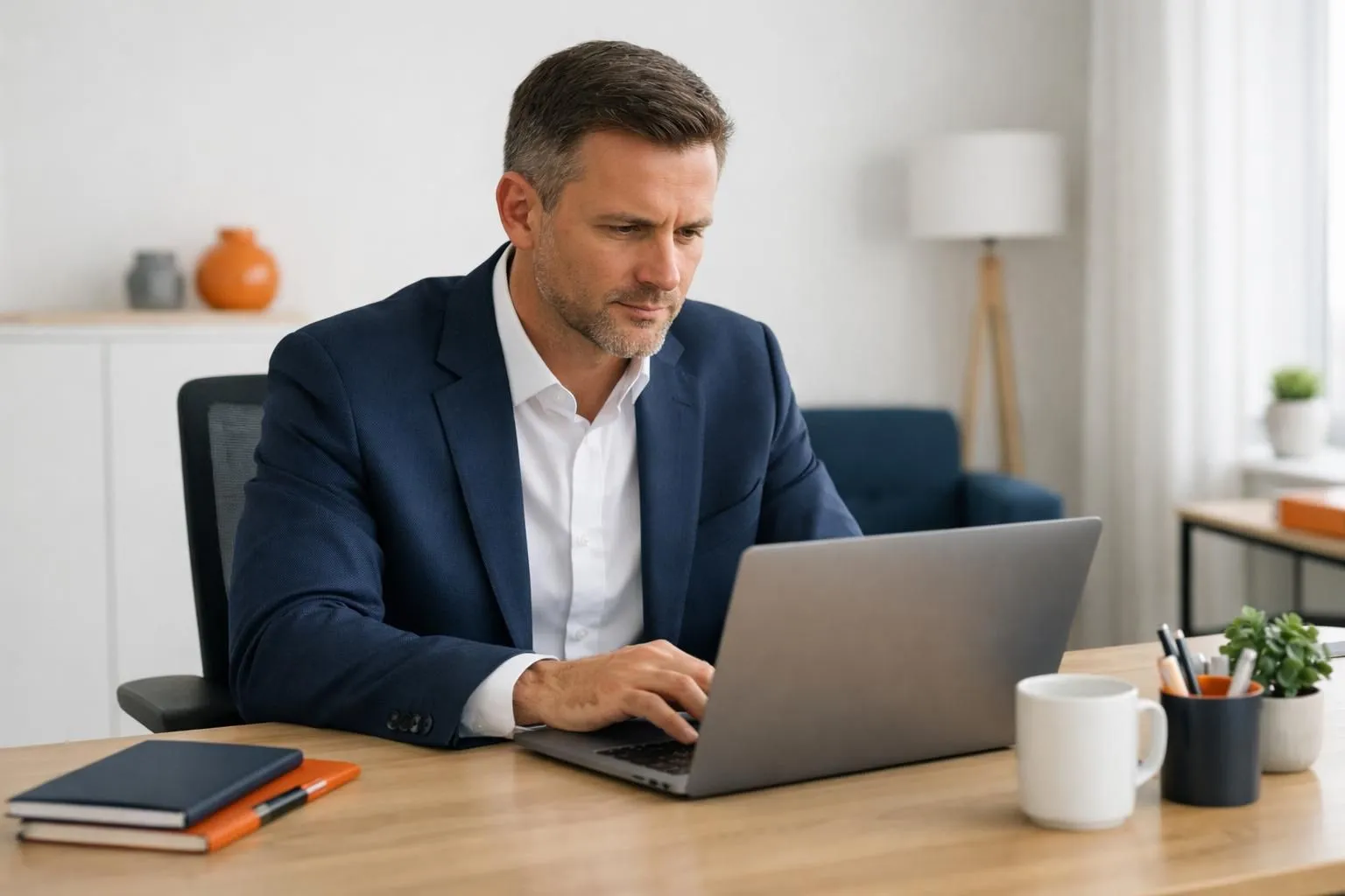 Business owner sitting at desk looking frustrated at laptop screen showing declining SEO analytics graphs and red downward arrows, office setting with worried expression, professional photography style