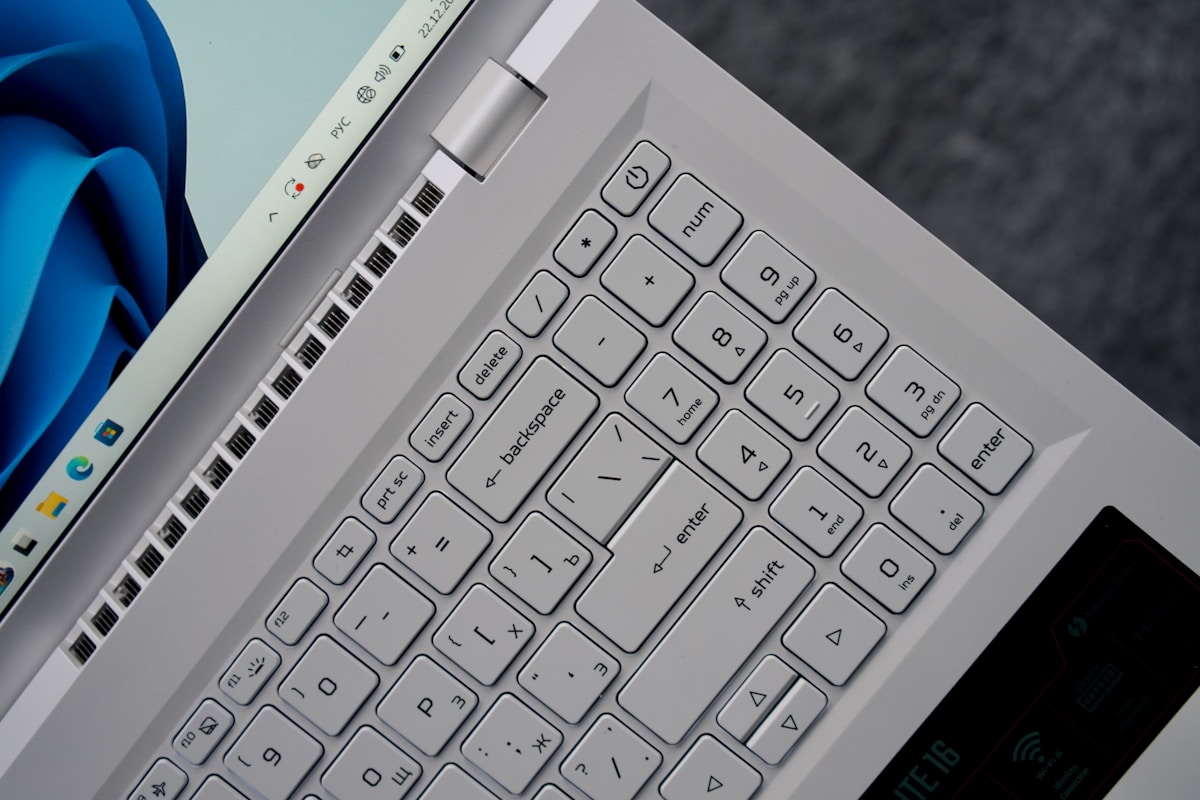 Close-up of a silver laptop keyboard and screen.