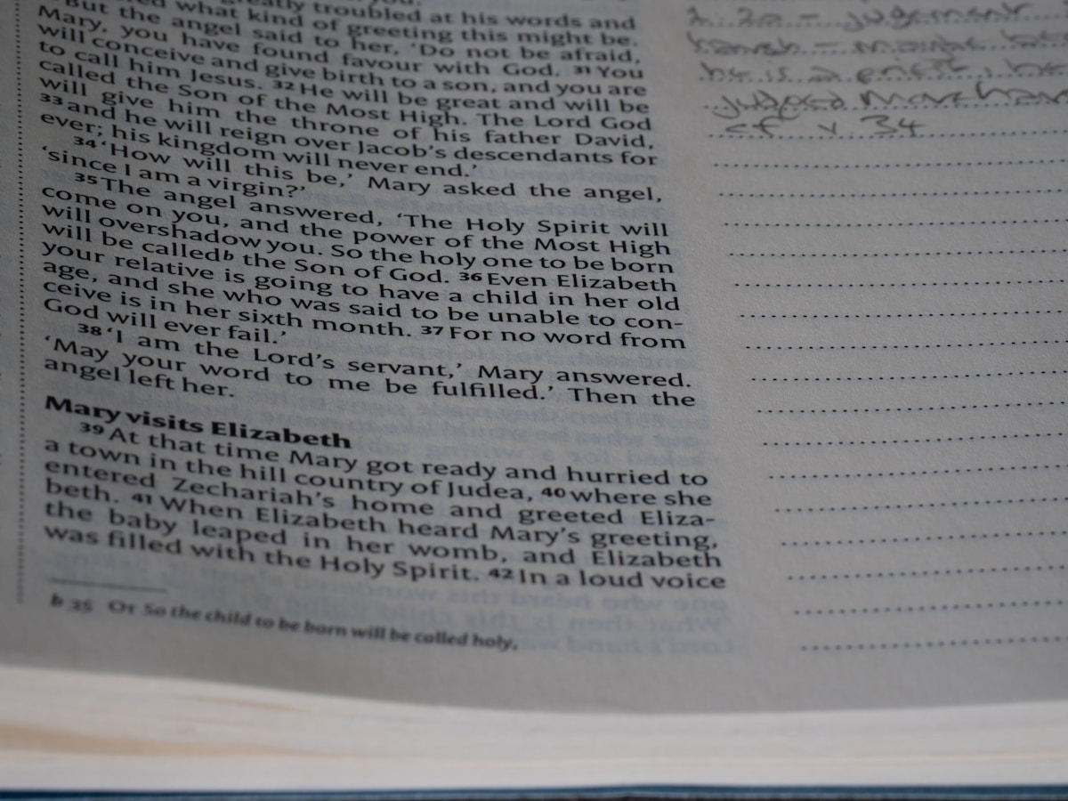 A close up of an open book with writing on it