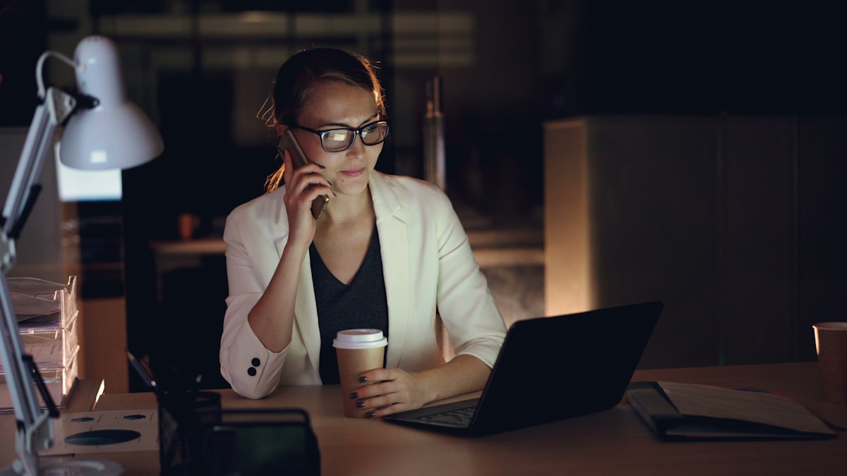 Femme d'affaires travaillant tard dans la nuit au bureau.