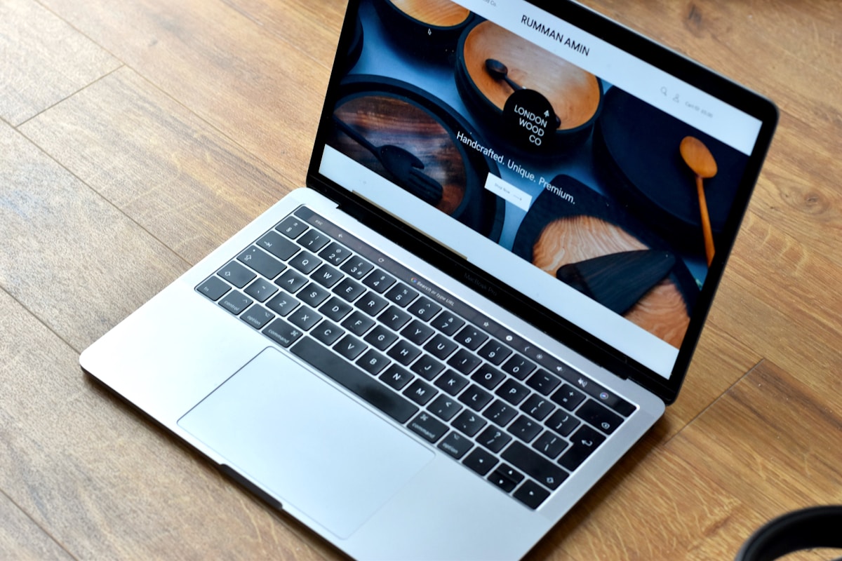 Ordinateur portable avec site web de produits en bois artisanaux sur l'écran.
