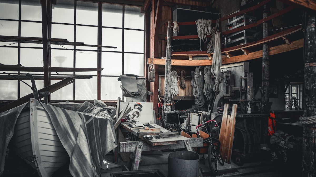 Atelier de bricolage encombré, rempli d'outils et de matériaux divers.