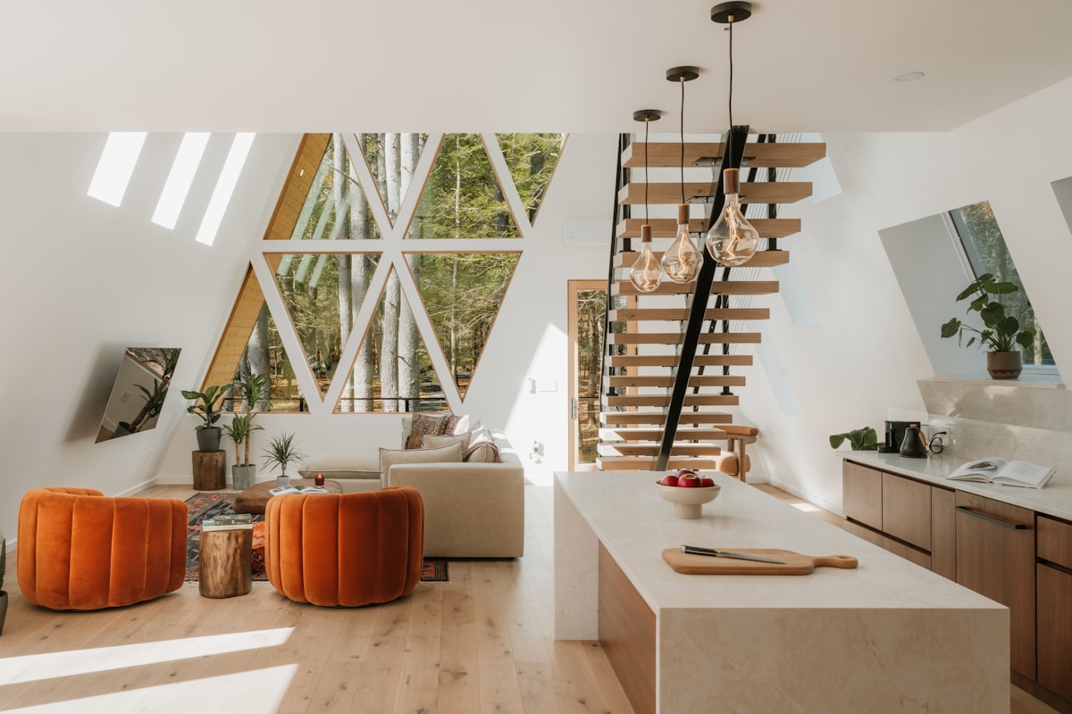 Modern a-frame interior with living area and kitchen.