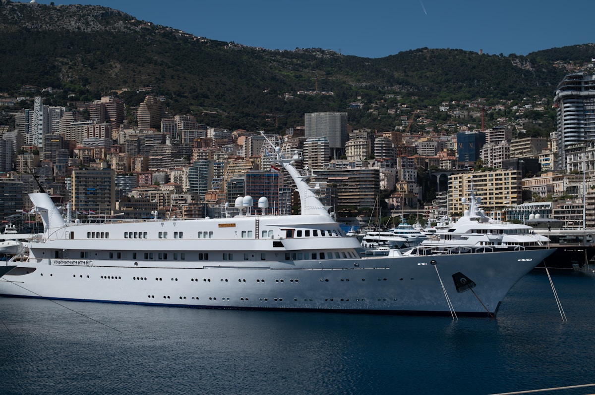Luxury yacht docked in a city harbor.