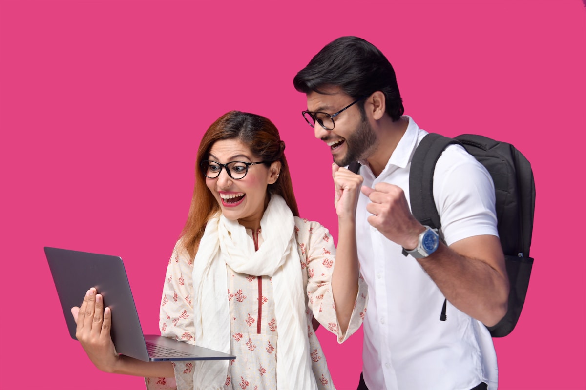 a man and a woman looking at a laptop
