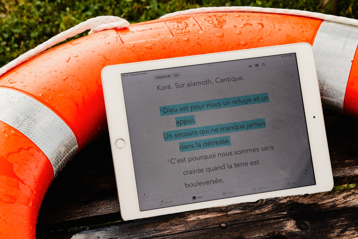a tablet sitting on top of a wooden bench