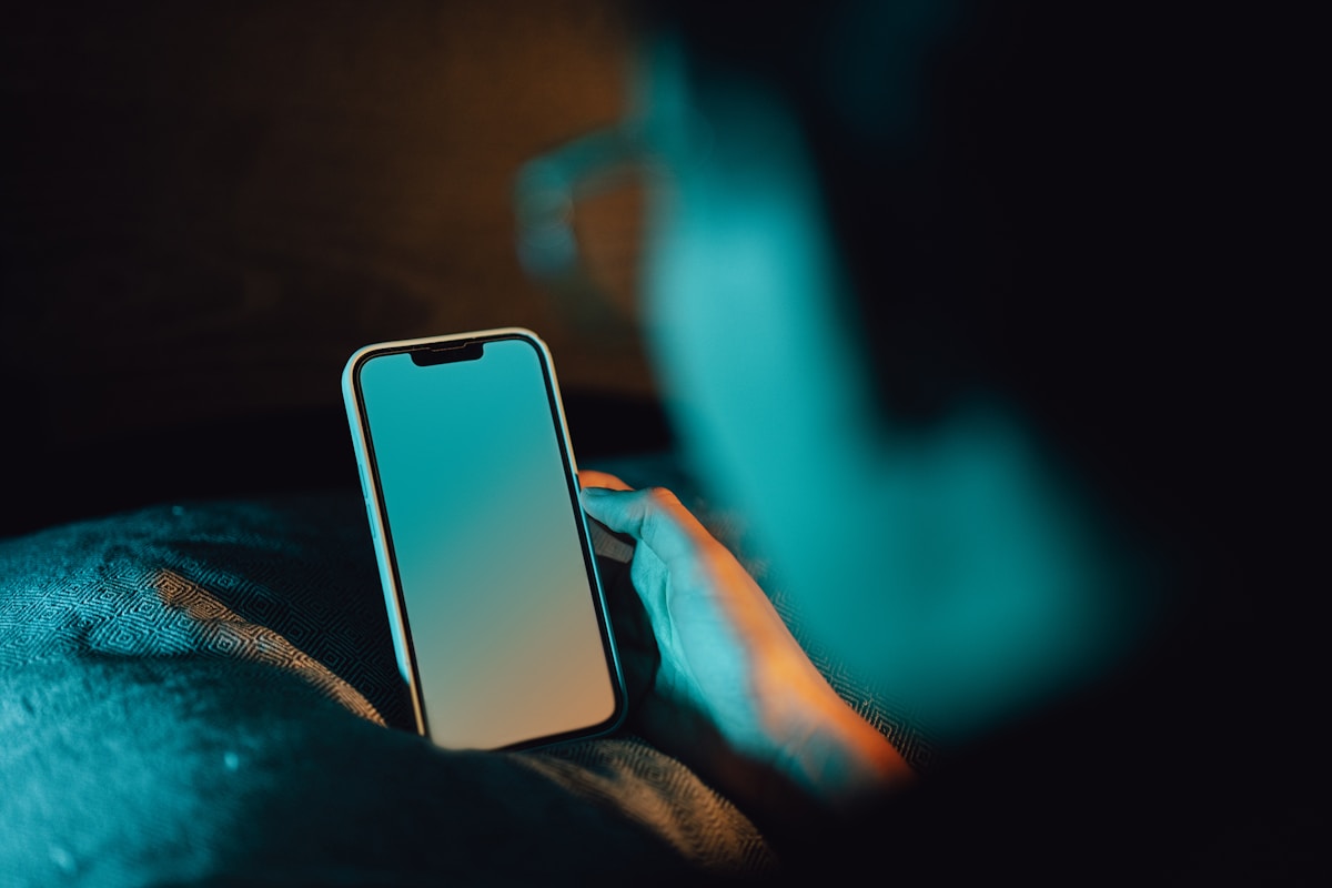 A person holding a cell phone in their hand