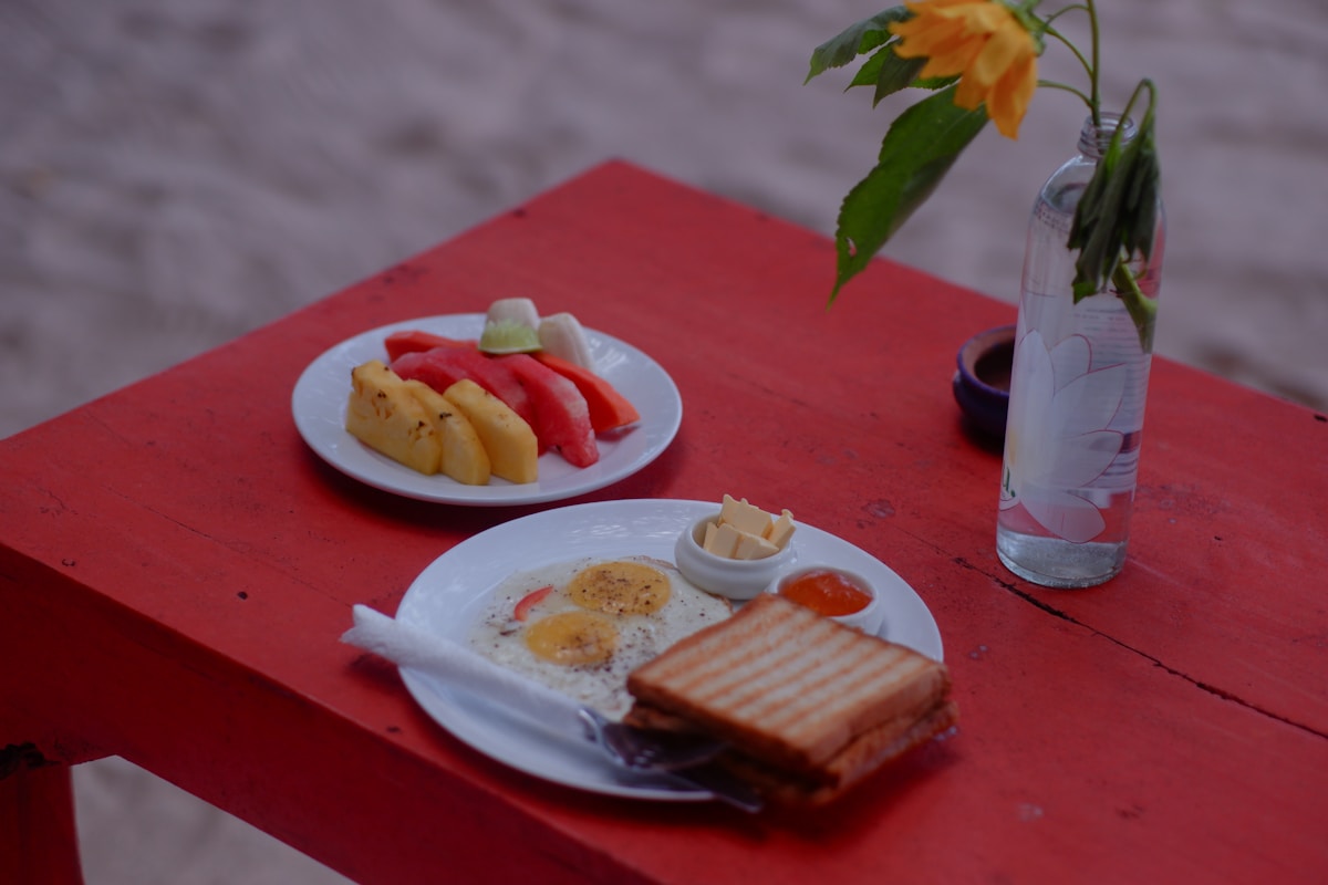 A table with breakfast and fruit salad
