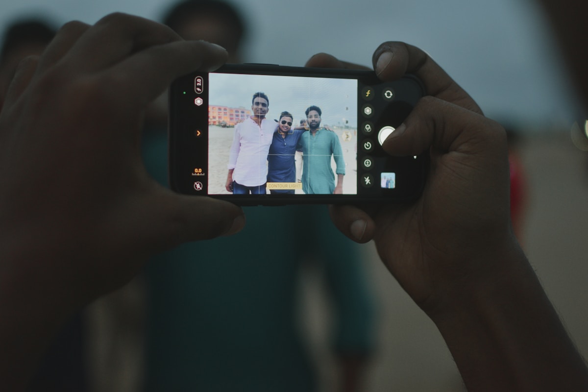 a person taking a picture with a cell phone