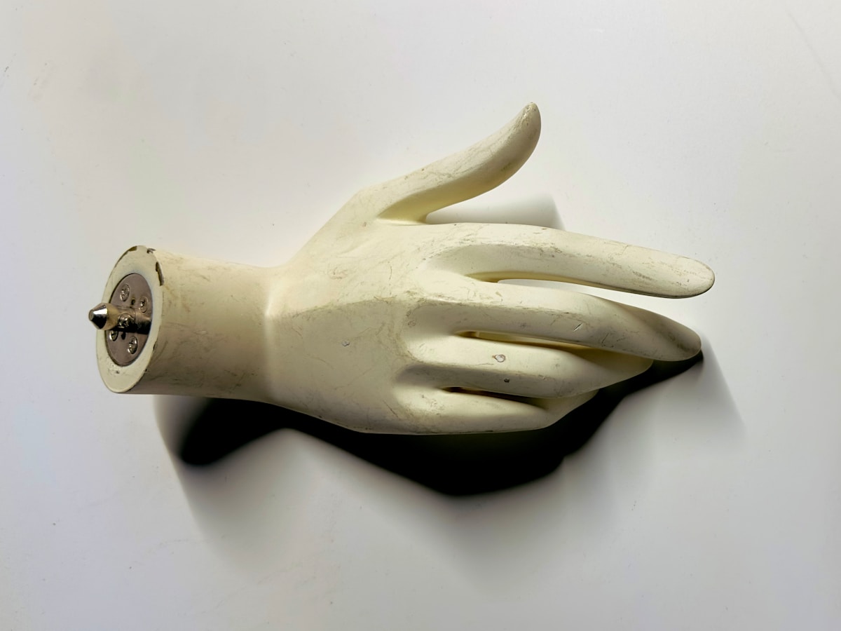 A white glove with a button on it