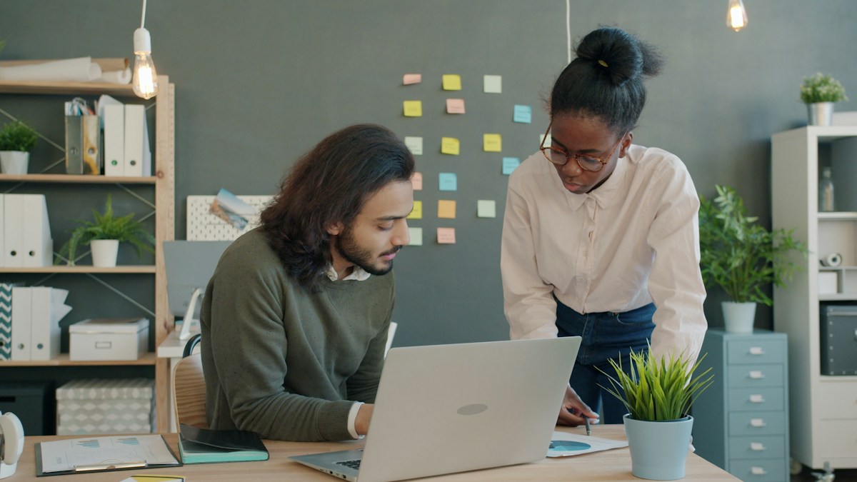 Two colleagues collaborating on a project at a desk