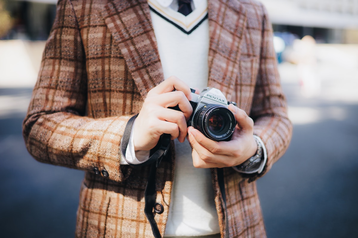 A man in a suit holding a camera