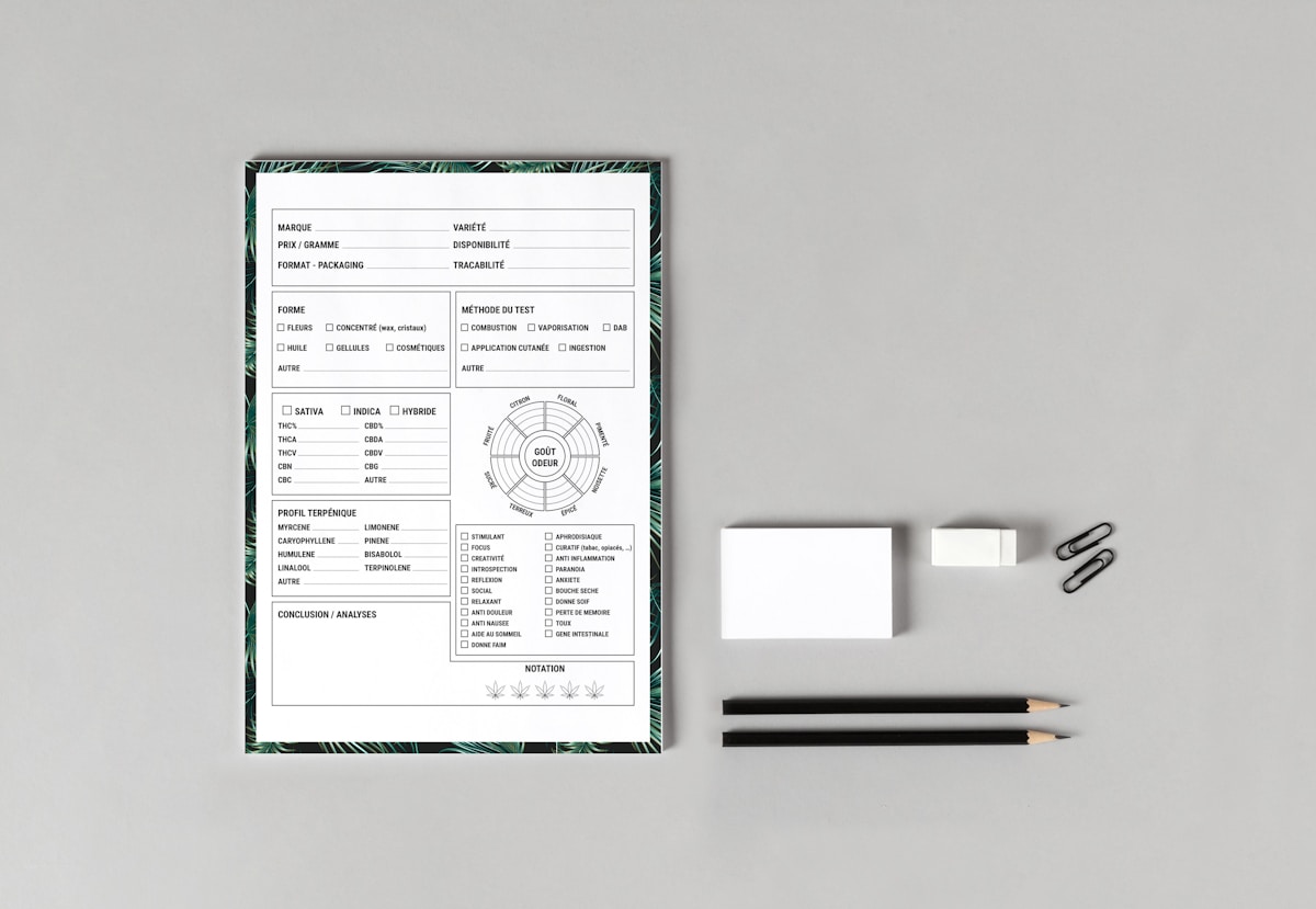 a table with a pen, pencil, and paper on it