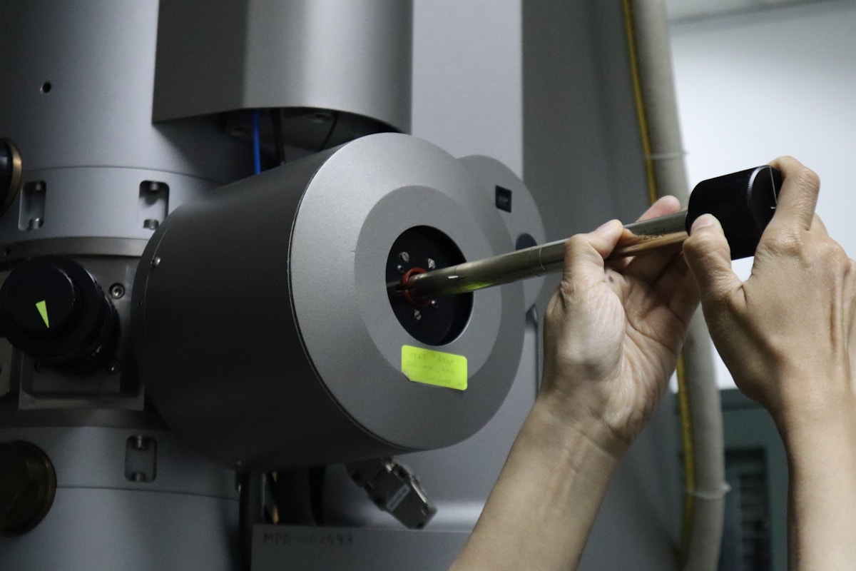 A scientist works with a complex laboratory device.