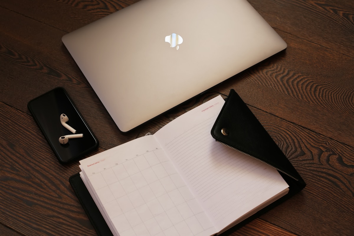 silver macbook beside black iphone 5