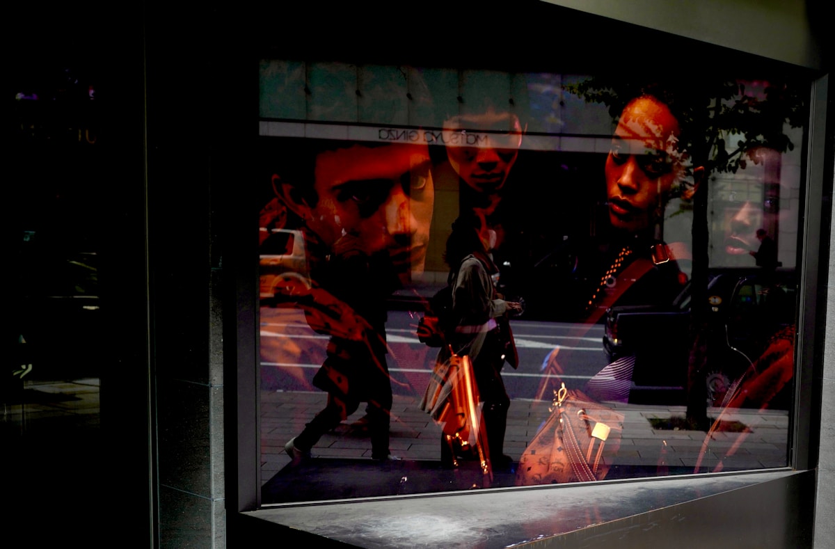 a reflection of two men in a window