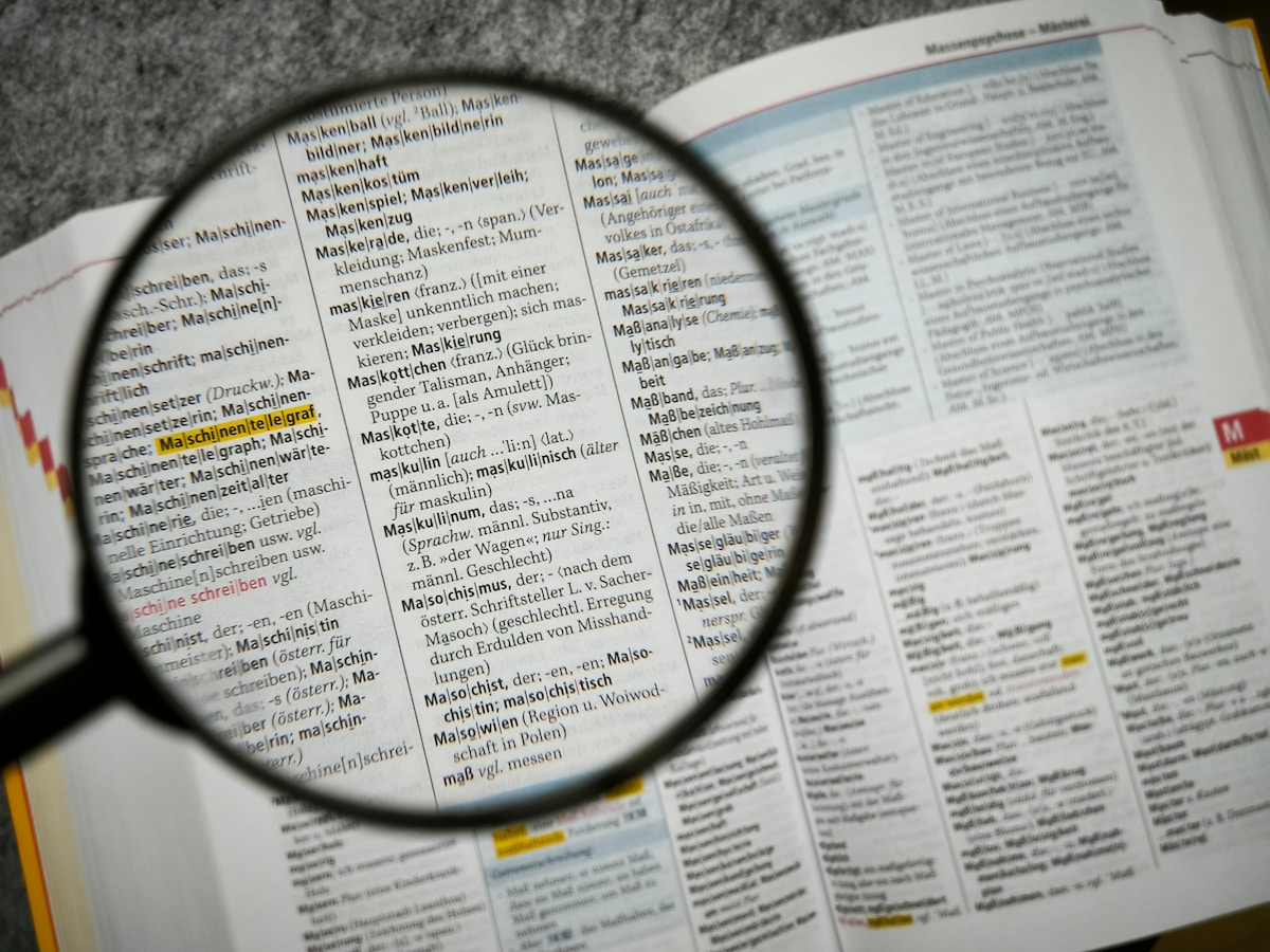 Magnifying glass focuses on a dictionary page