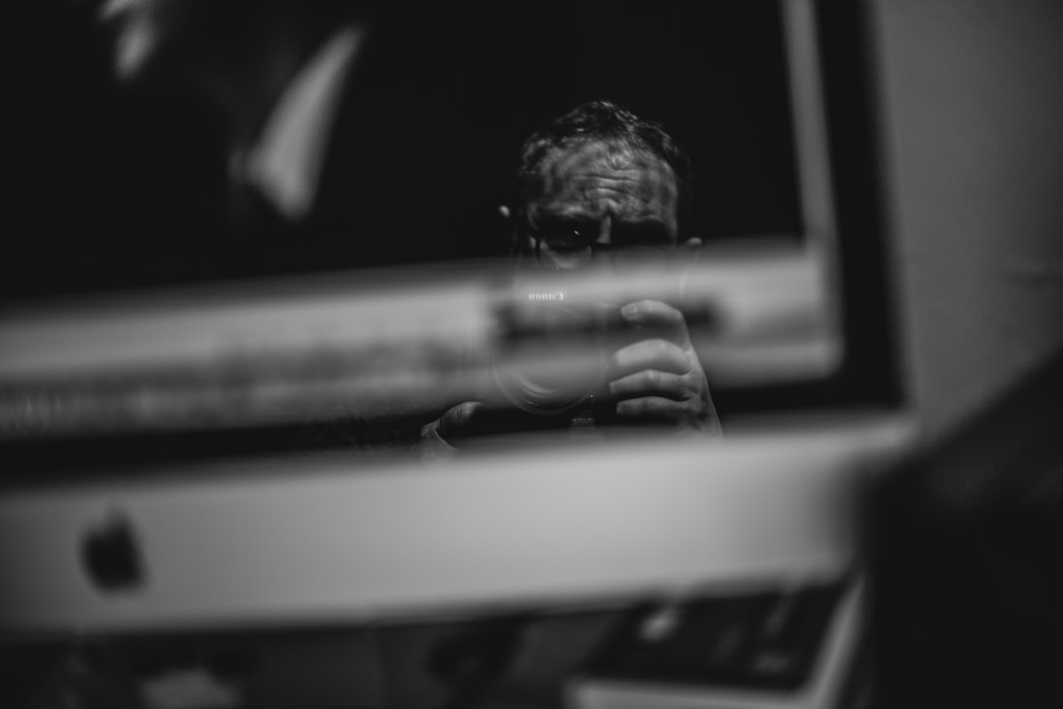 Man reflected in a computer screen