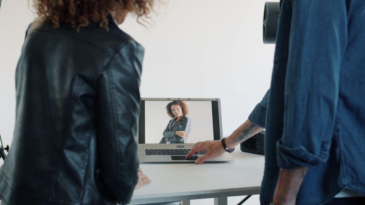 Two people looking at a laptop screen