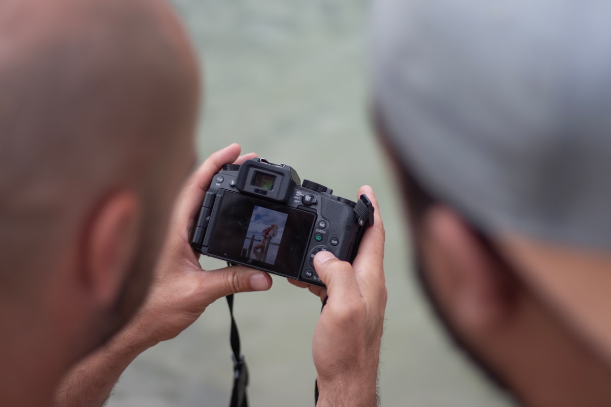 person holding black dslr camera
