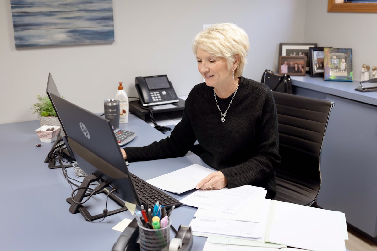 Woman works on laptop at her office desk