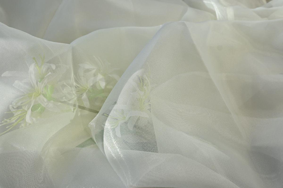 White sheer fabric is gently draped and folded.