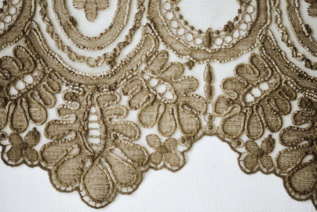 Detailed brown lace border on white