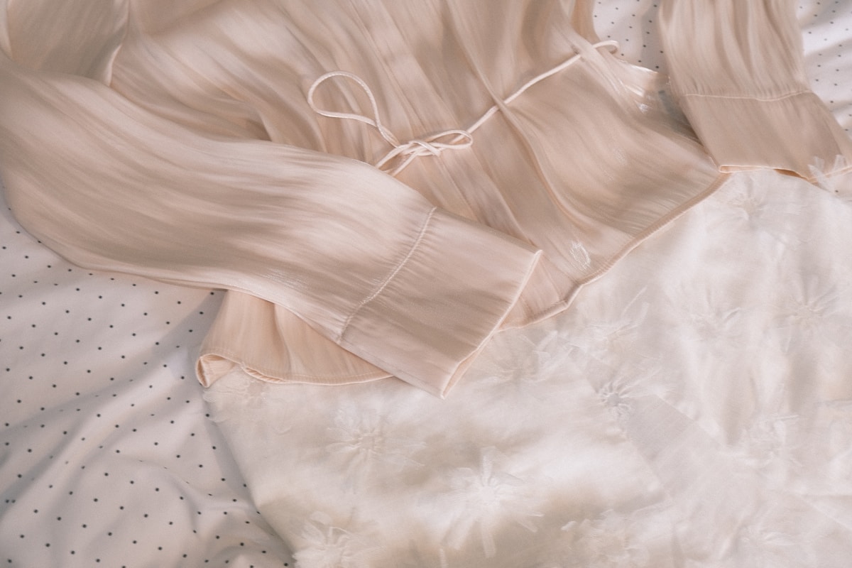 A light pink blouse with a tie waist