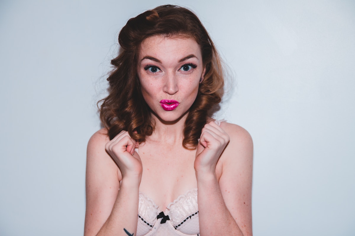 woman wearing white brassiere taking selfie