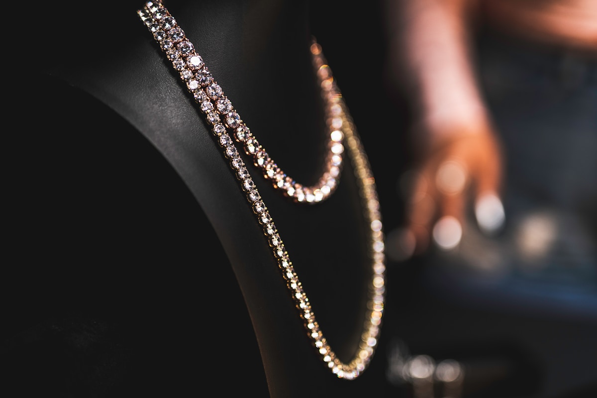 a close up of a diamond necklace on a chair