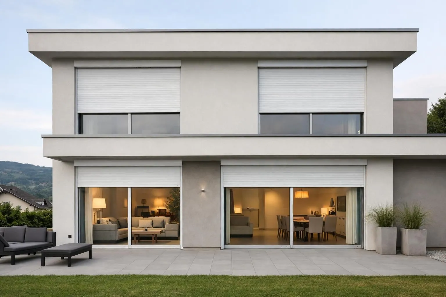 Modern Swiss home facade with sleek motorized roller shutters in neutral tones, large windows with automated white roller blinds, contemporary residential architecture in Suisse Romande, comfortable living space visible through windows, subtle warm lighting inside, clean minimalist design, daytime natural light, ABSOLUTELY NO TEXT, words, letters, numbers, signs, labels, logos, titles, or captions in the image