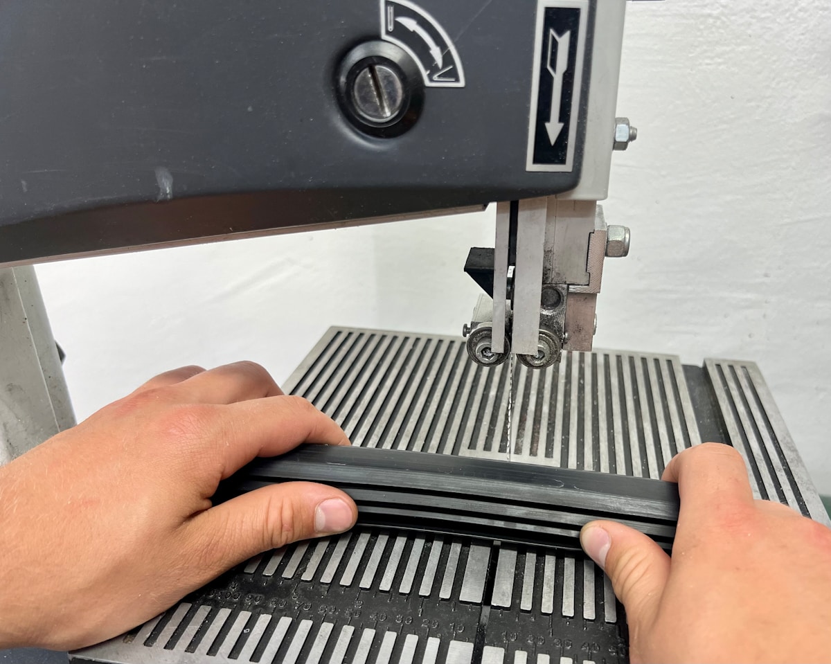 a person using a sewing machine to sew a piece of fabric