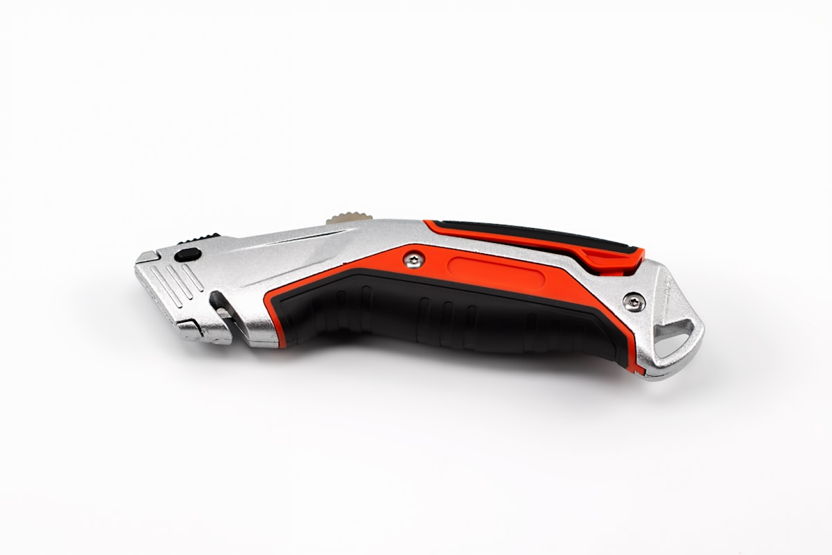 Utility knife with silver and orange accents