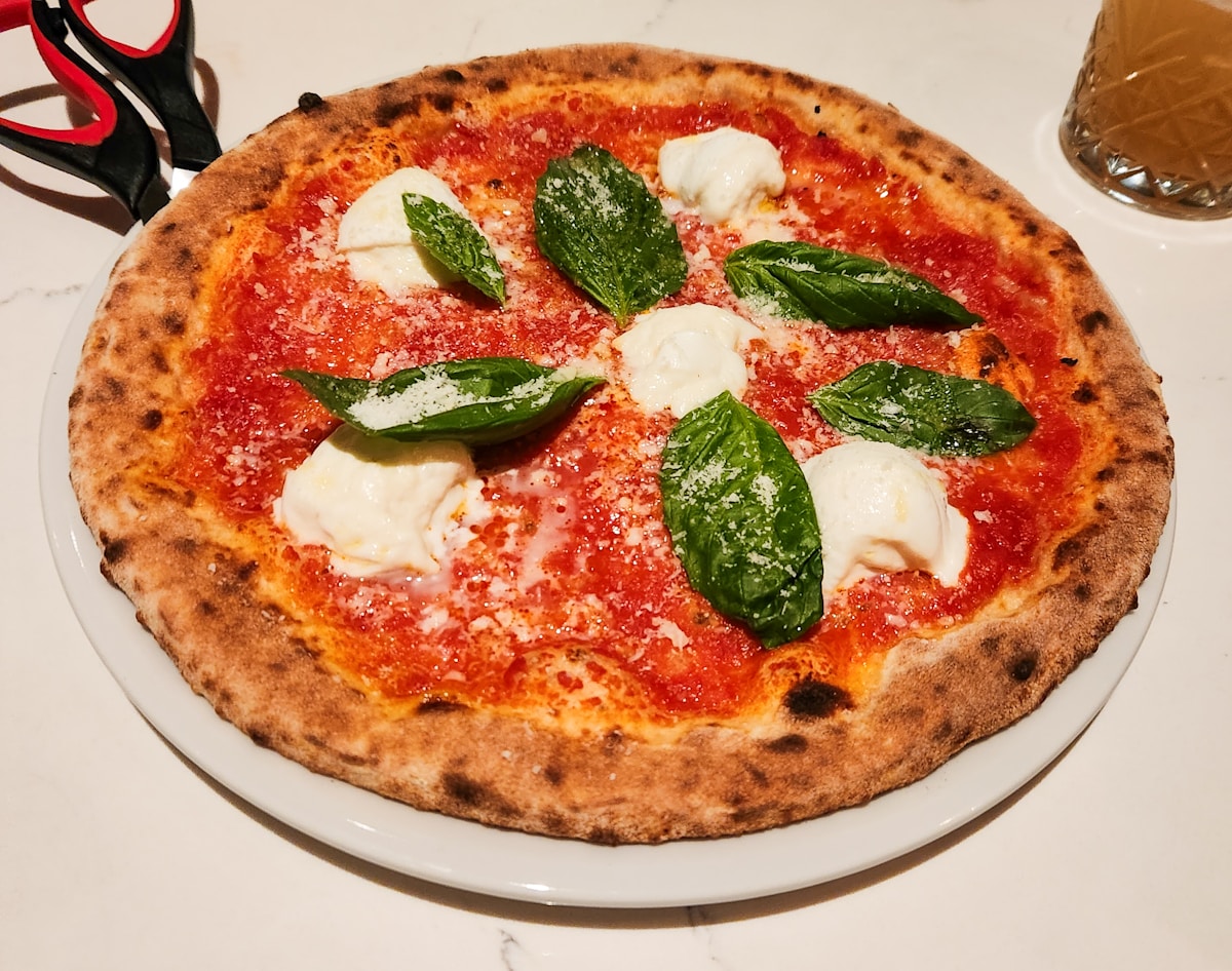 A delicious pizza with mozzarella and basil.