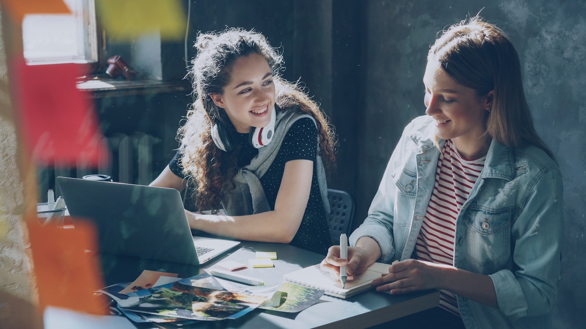 Deux jeunes femmes travaillant ensemble sur un projet créatif.