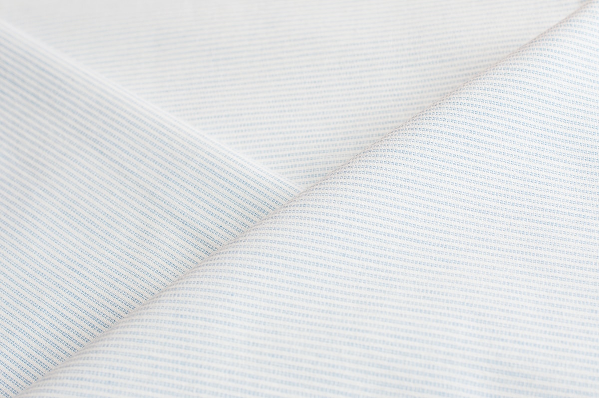 White fabric with subtle vertical stripes